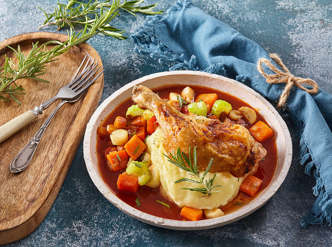 Baked chicken legs with root vegetables and potato mash