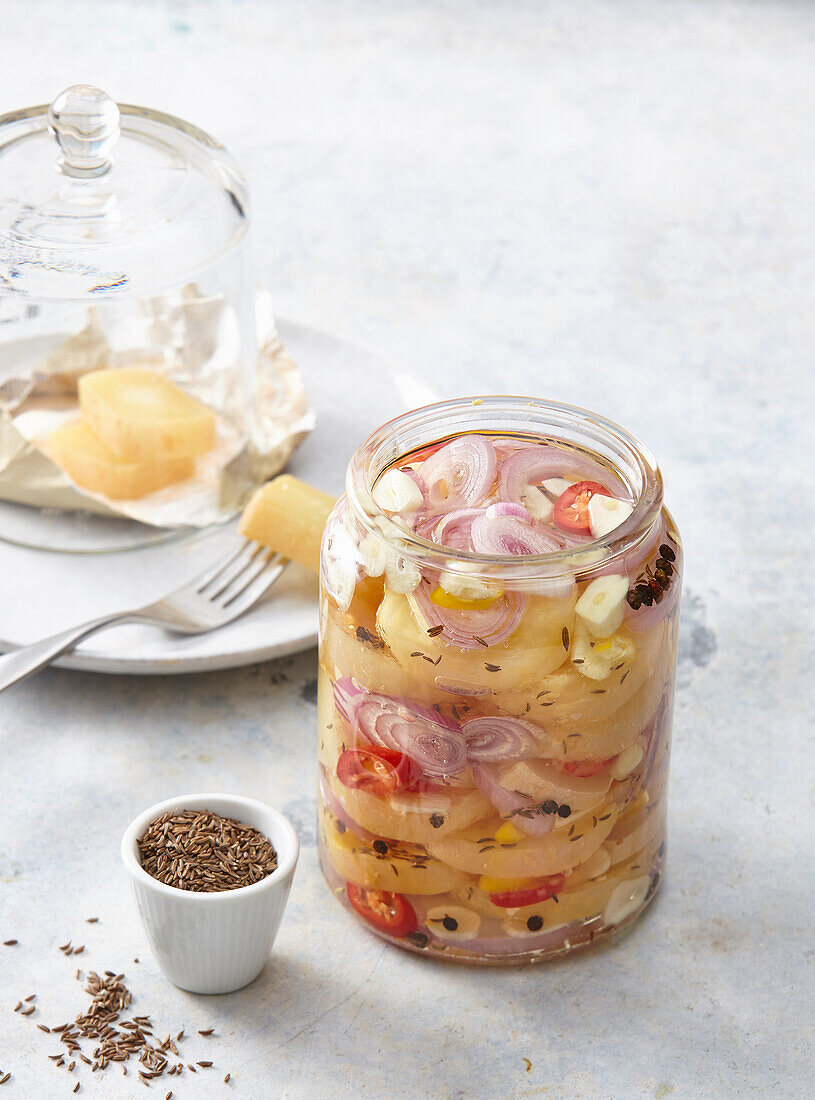 Spicy pickled cheese with chilli, red onions and cumin seeds