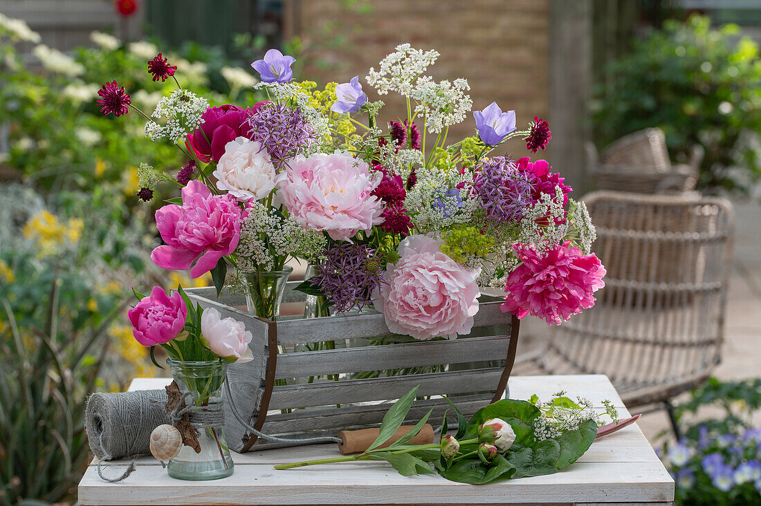 Flower arrangement of peonies, bellflowers, goutweed, ornamental leeks and astrantia