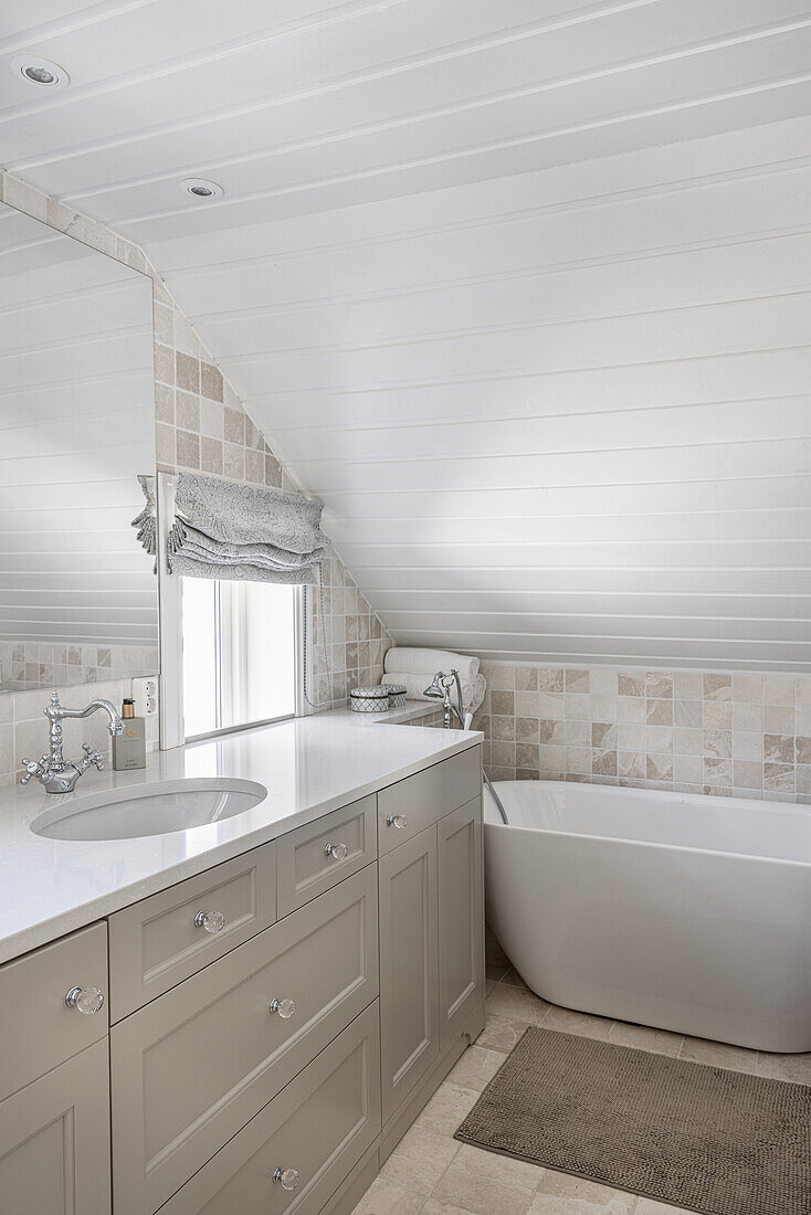 Bright bathroom with window in the attic