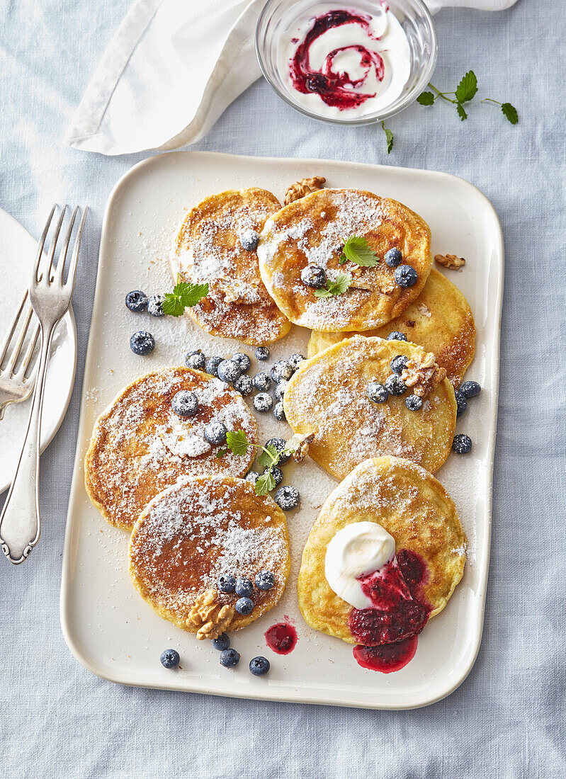 Pancakes with blueberry jam, yogurt, and walnuts