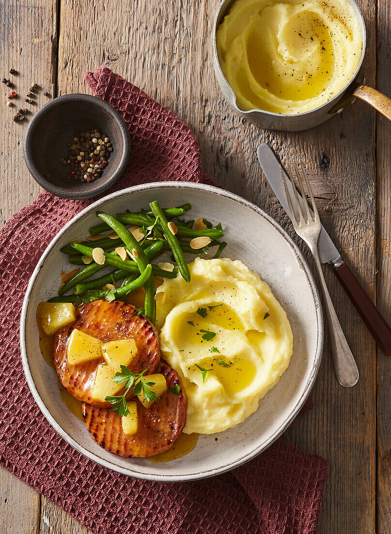 Ham steaks with pineapple glaze, beans, and mashed potatoes