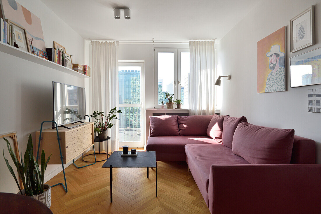 Lilac-colored sofa, coffee table and TV cabinet in the living room