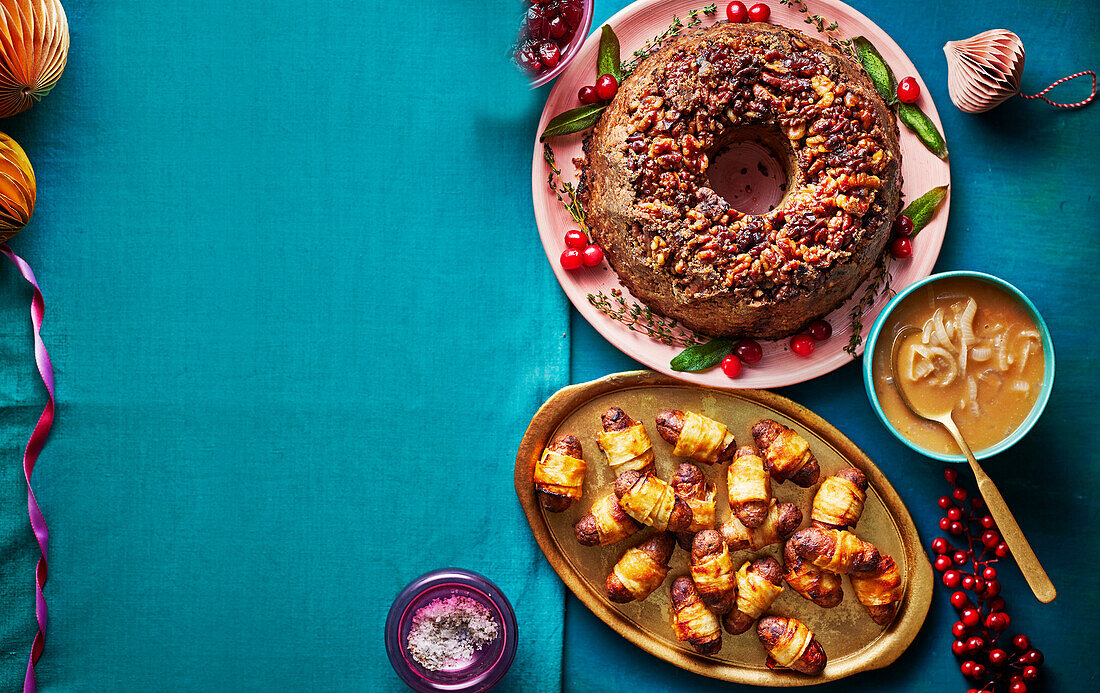 Parsnip nut roast in wreath form with Marsala sauce and vegetarian sausages in parsnip coating