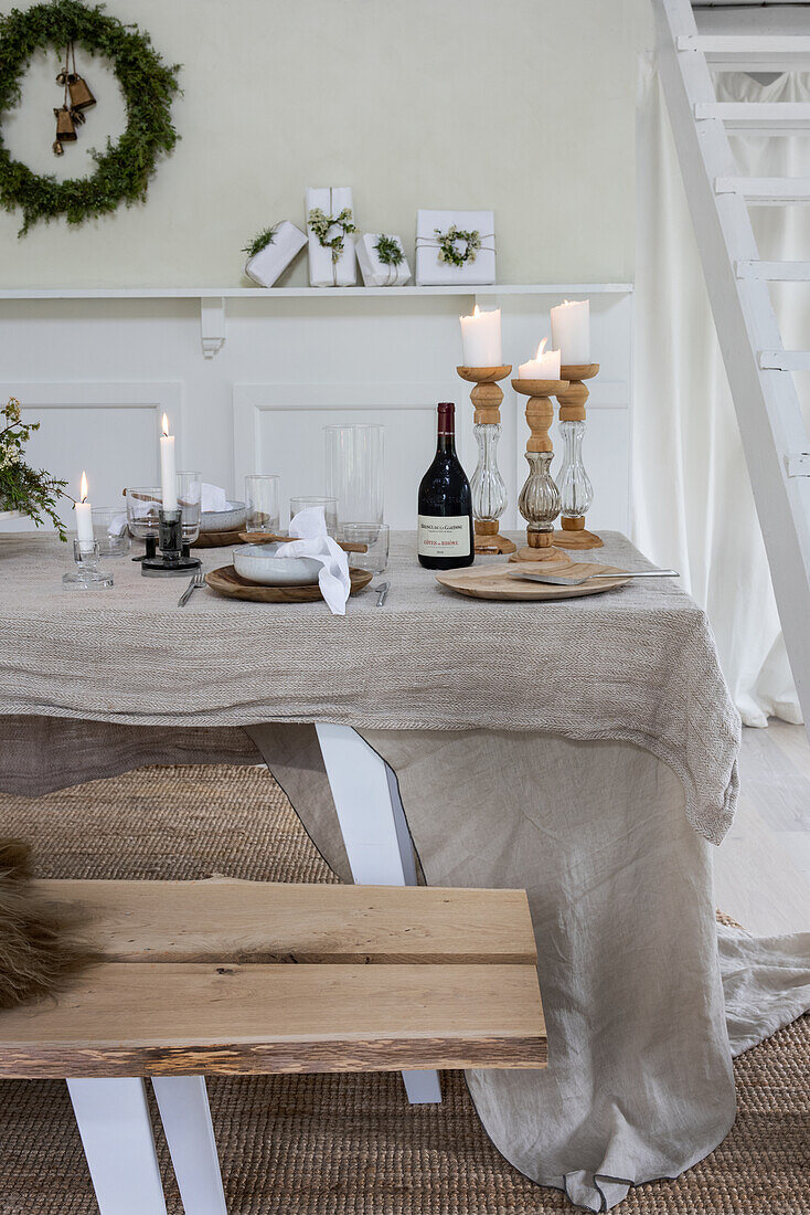 Set dining table with linen tablecloth and candles, Christmas decorations