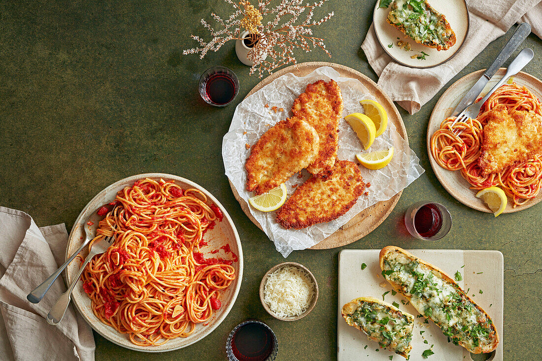 Spicy spaghetti marinara, chicken Milanese, and garlic bread