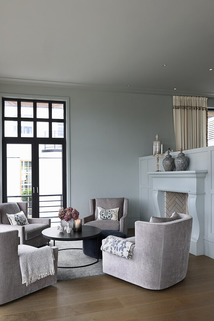 Comfortable armchairs and coffee table in front of the fireplace