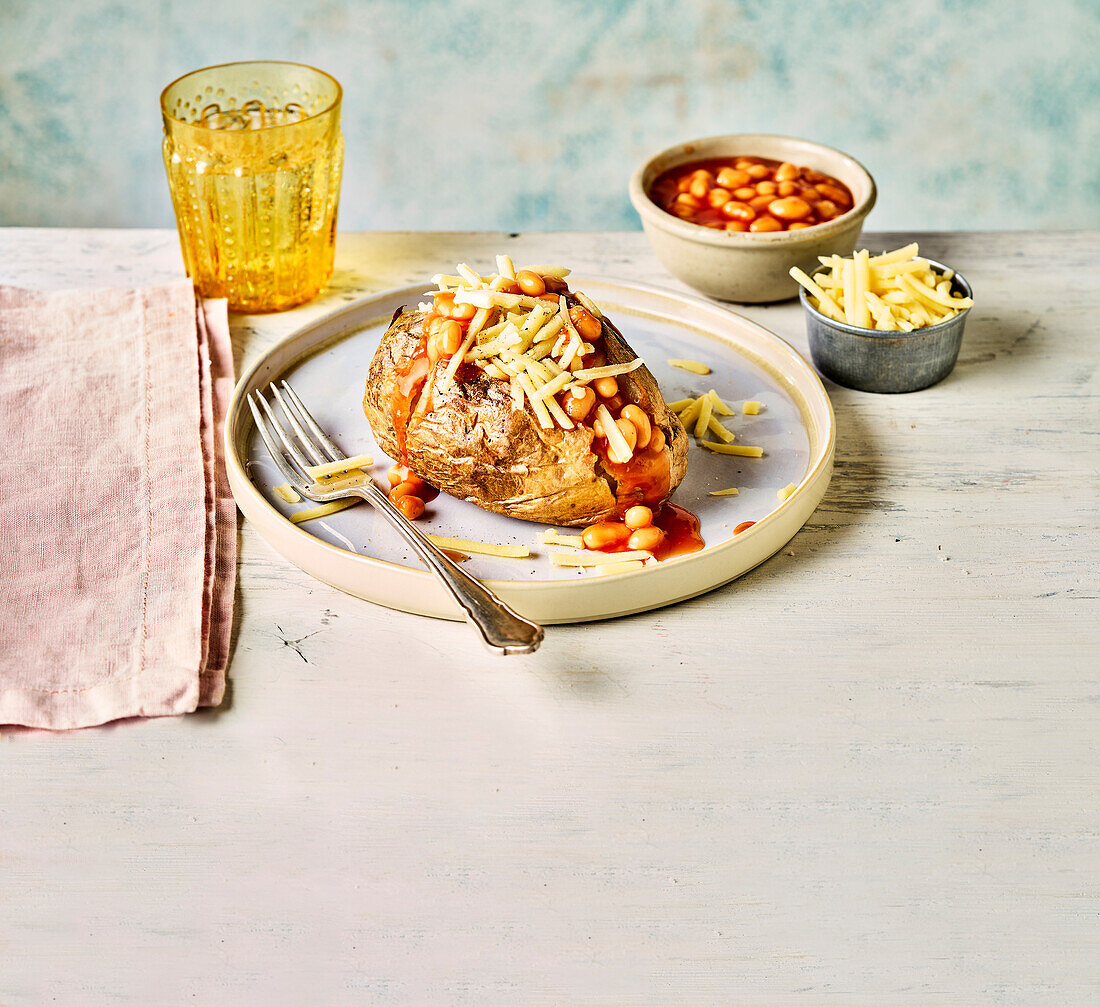 Baked potato with baked beans and cheese cooked in a hot air fryer