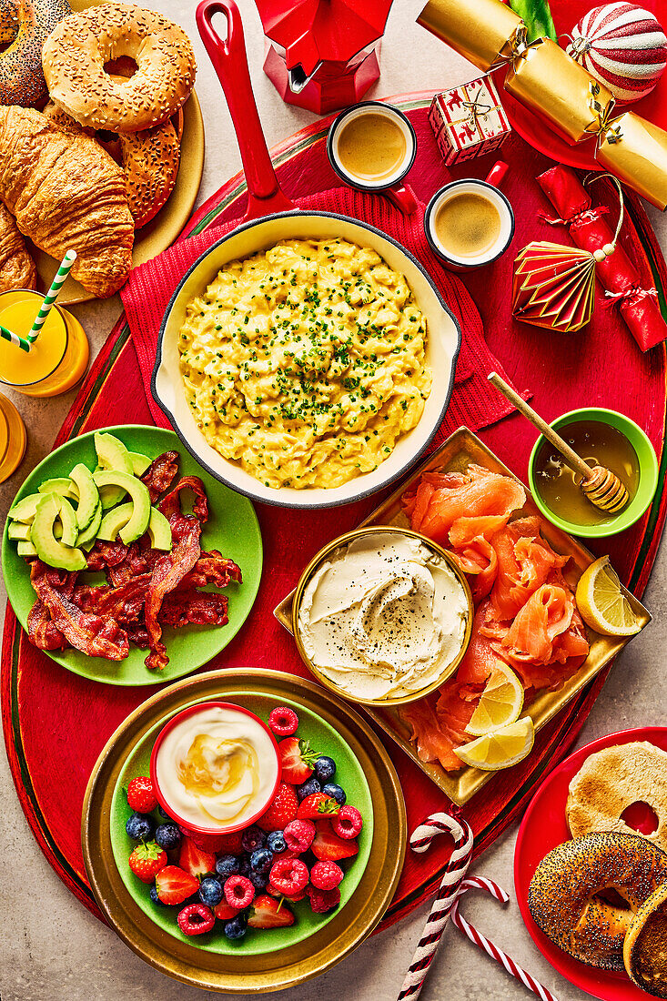 Christmas family breakfast with bacon, scrambled eggs, salmon, and berries