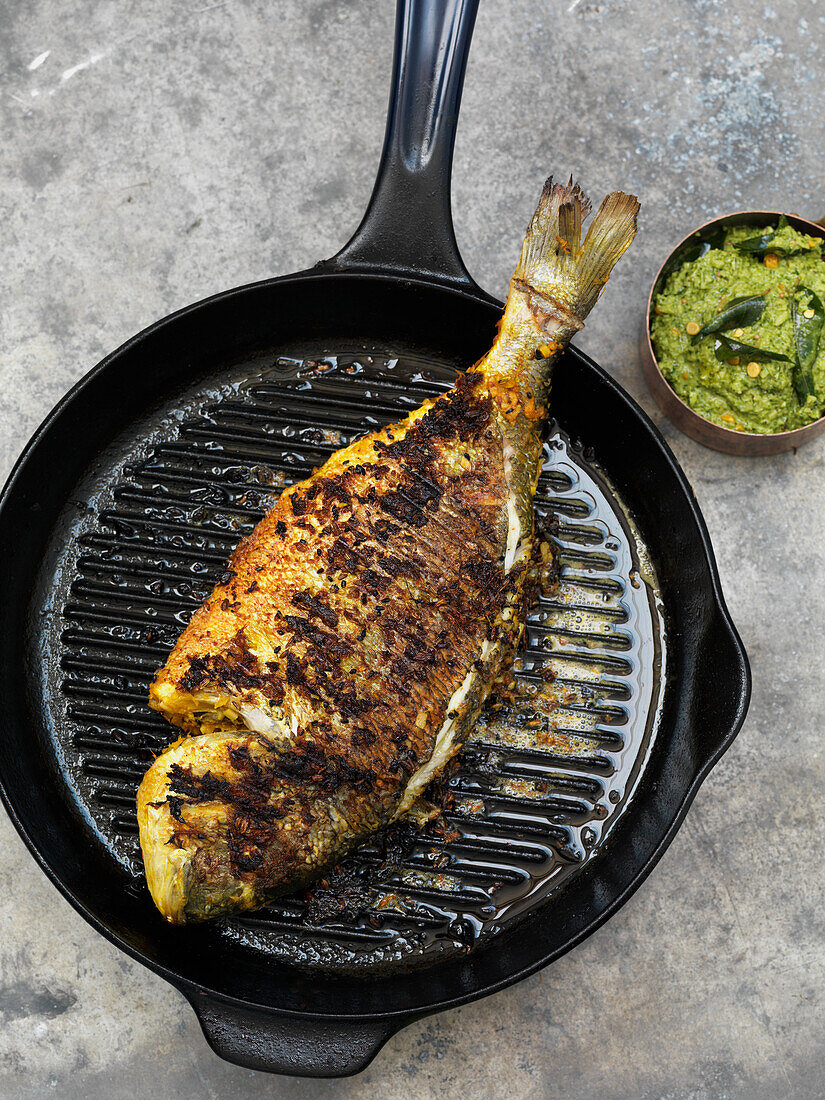 Whole gilt-head bream roasted in the grill pan