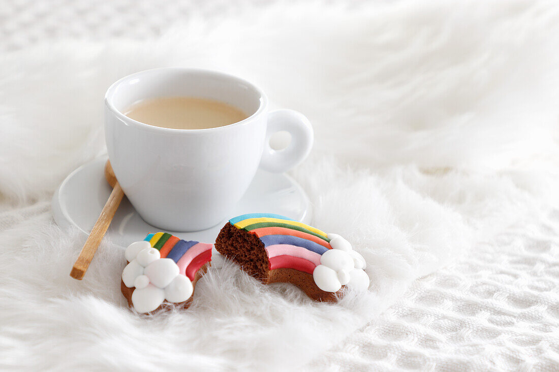 Rainbow biscuits with a cup of coffee