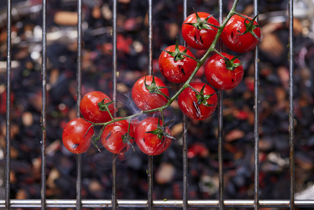 Grilled cherry tomatoes on a grill rack