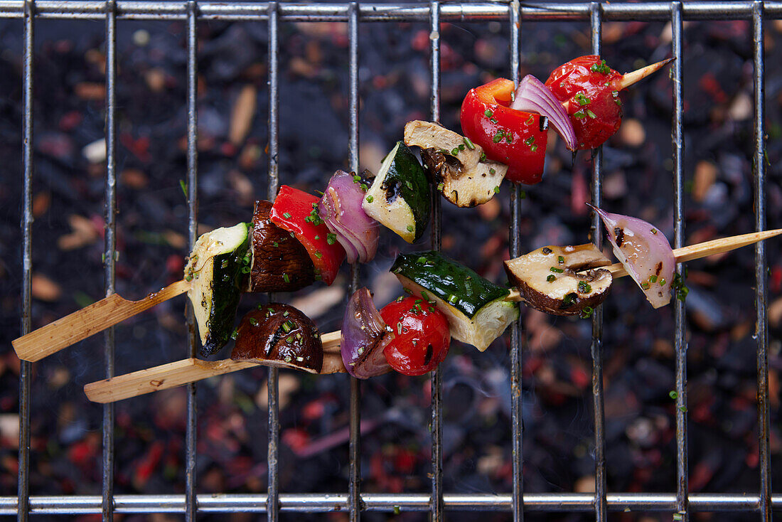 Grilled vegetable skewers on a grill grate