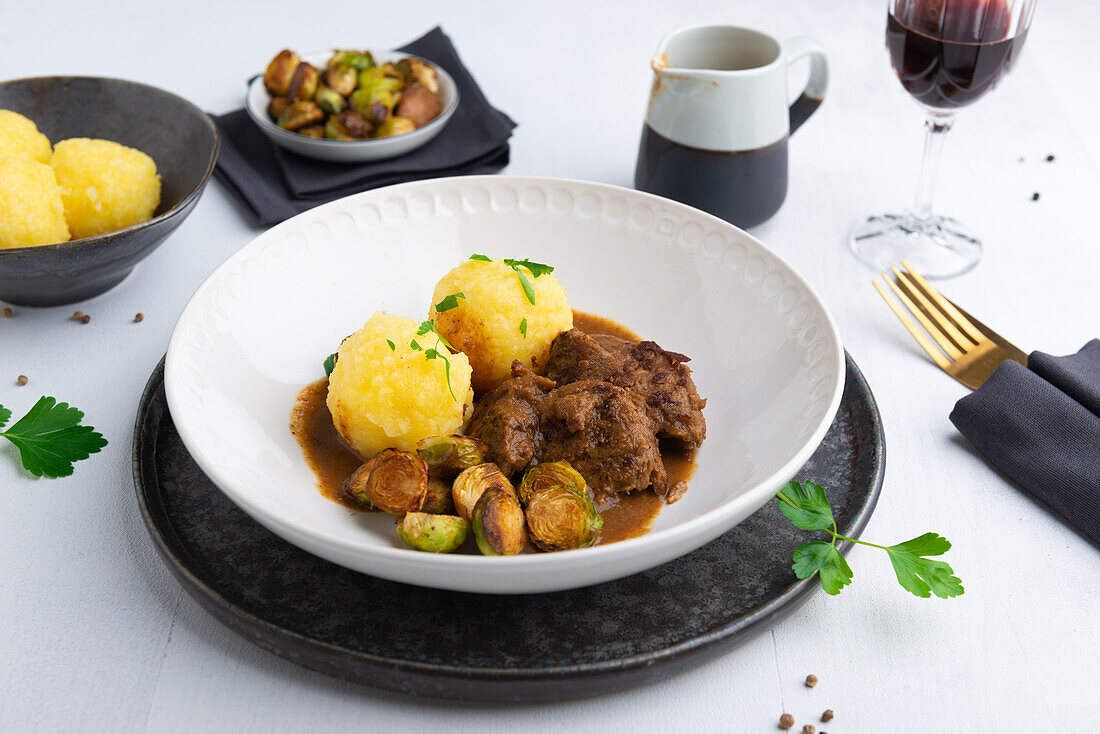 Vegan 'duck' fillets with baked Brussels sprouts and dumplings