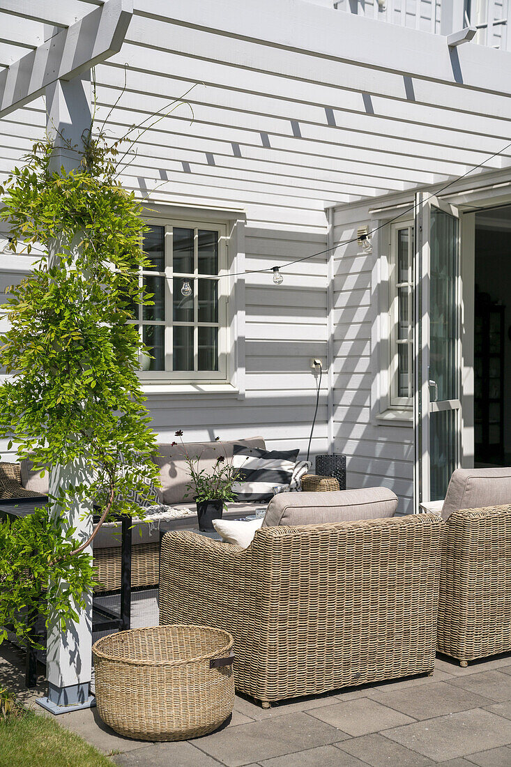 Sunny terrace with outdoor furniture and pergola