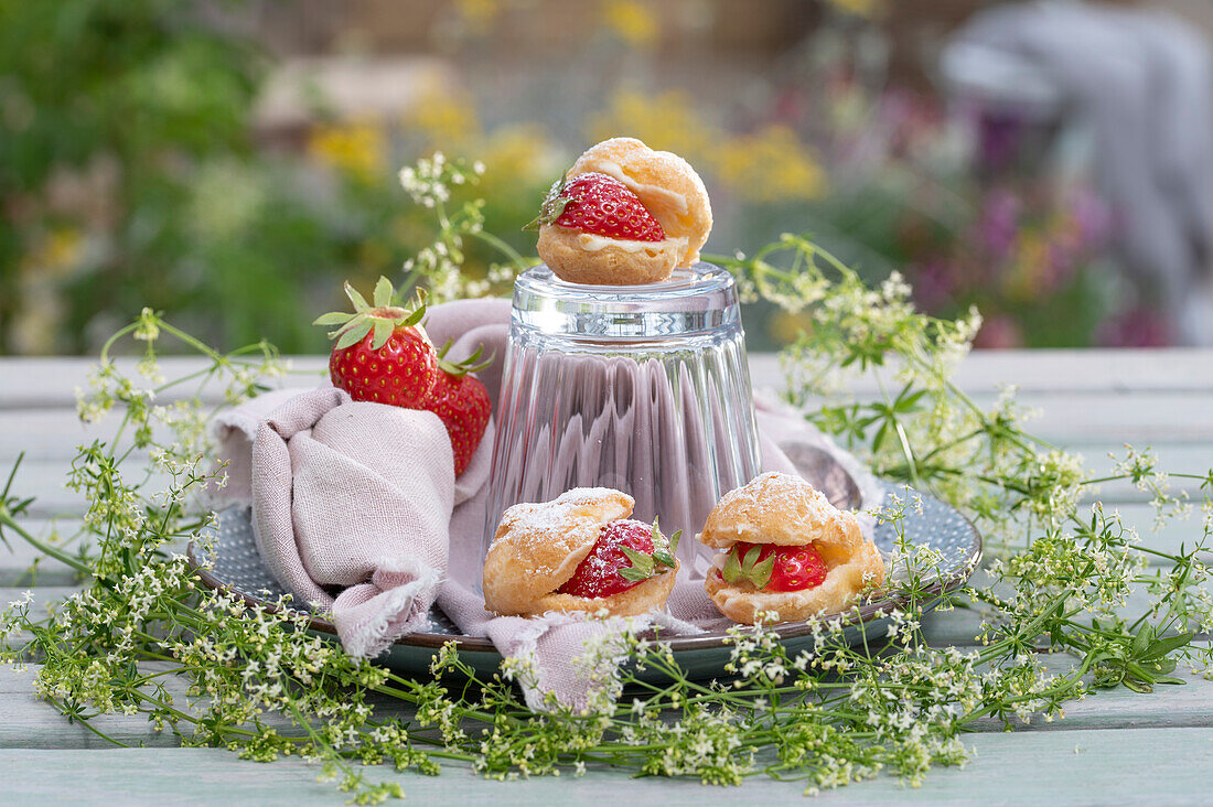 Mini strawberry cream puffs encircled with a wreath of white bedstraw