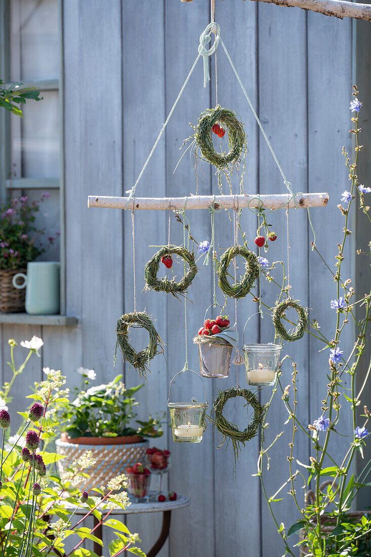 DIY mobile with grass wreaths, strawberries and lanterns