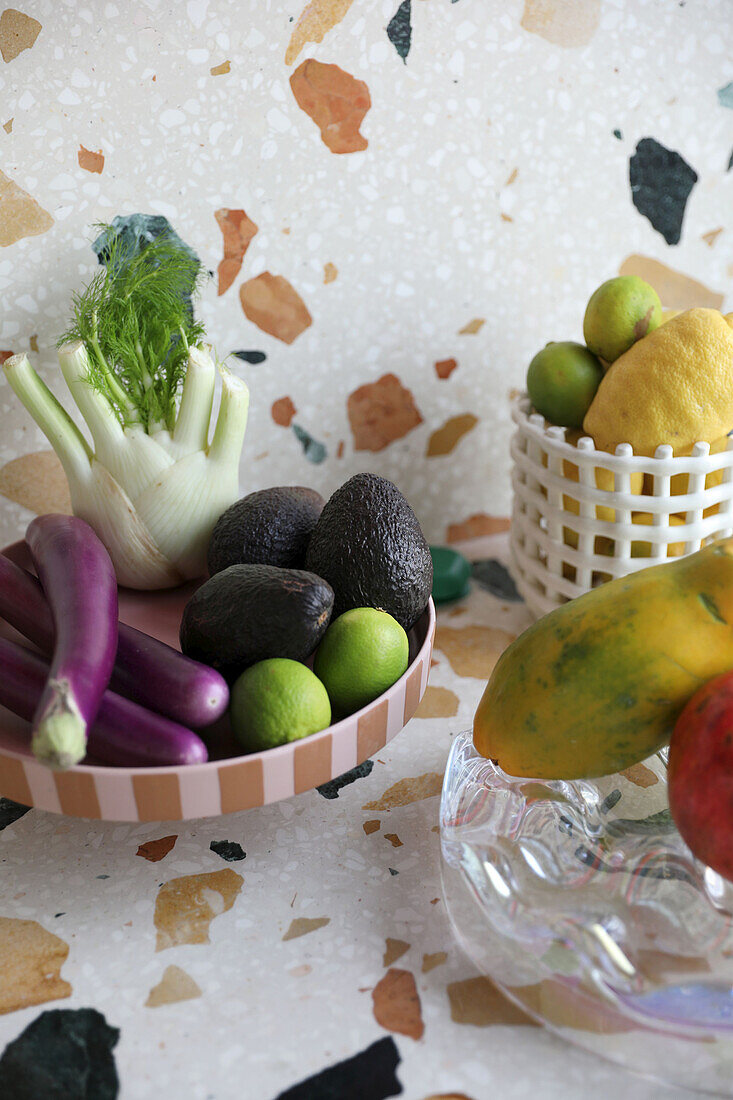 Fruit and vegetable bowls on marble terrazzo worktop