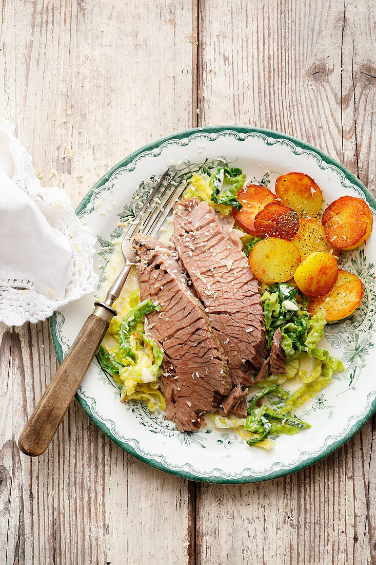 Bavarian boiled beef with creamy savoy cabbage and fried potatoes