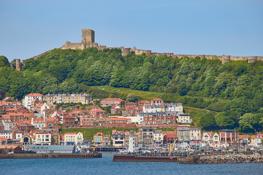 View of South Bay looking towards harbour and Scarborough Castle, Scarborough, Yorkshire, England, United Kingdom, Europe