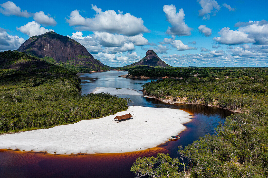 Black river and white sand beach in front of granite hills, Cerros de Mavecure, Eastern Colombia, South America