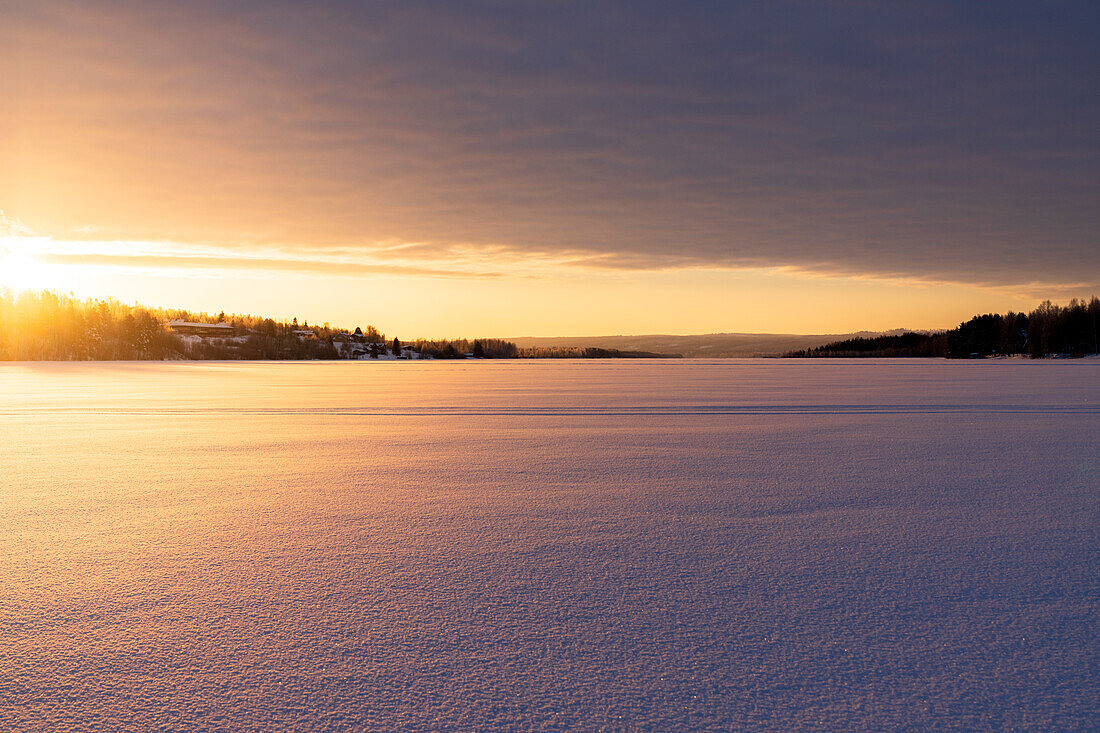 Arctic sunrise over the frozen landscape covered with snow in winter, Harads, Lapland, Sweden, Scandinavia, Europe