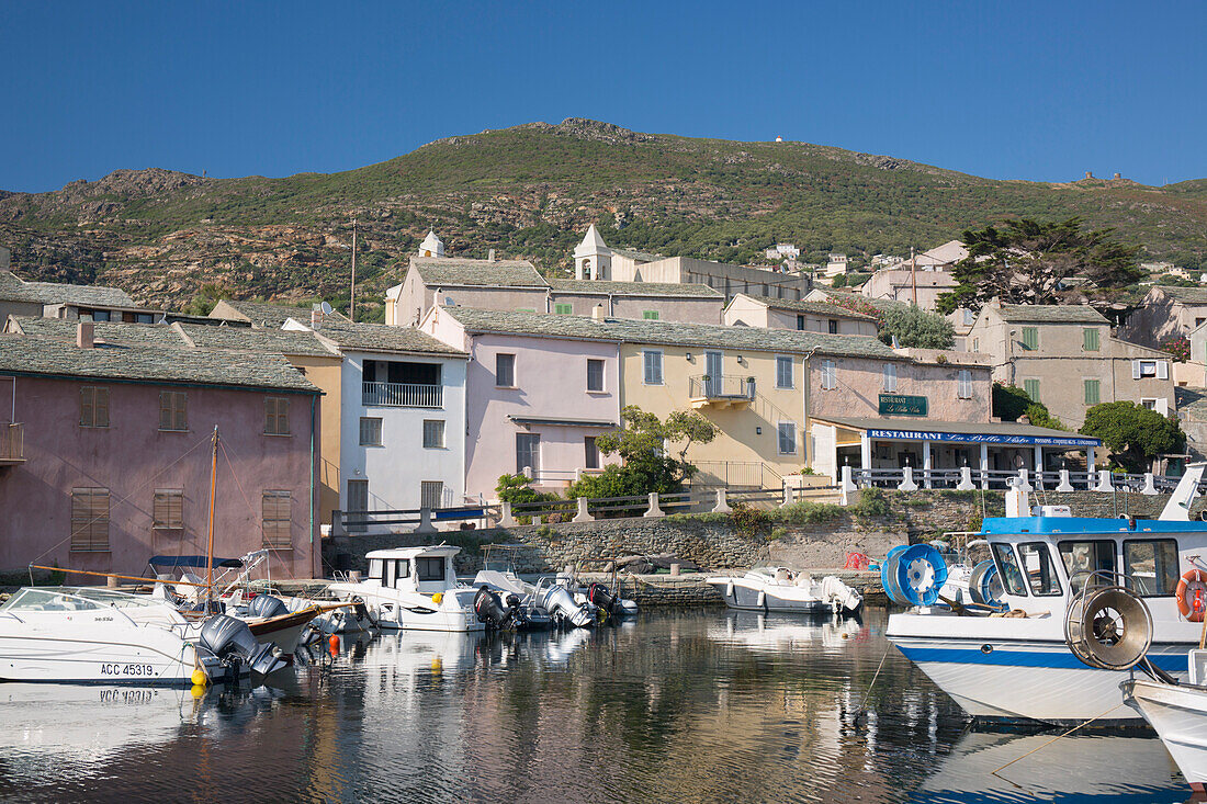 View across the tranquil harbour to typical slate-roofed houses, Centuri-Port (Port de Centuri), Haute-Corse, Corsica, France, Mediterranean, Europe