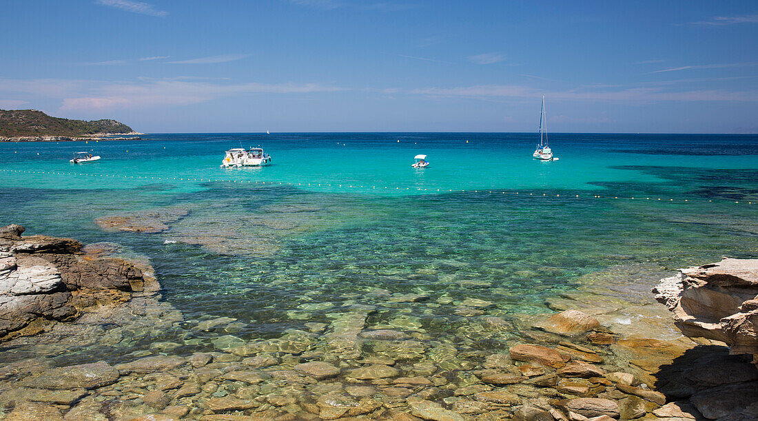 View across clear turquoise water from rocky coastline near the Plage du Loto, St-Florent, Haute-Corse, Corsica, France, Mediterranean, Europe