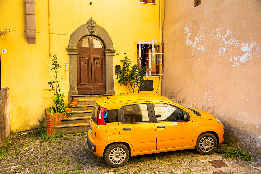 Parked car in front of house entrance, Barga, Tuscany, Italy, Europe