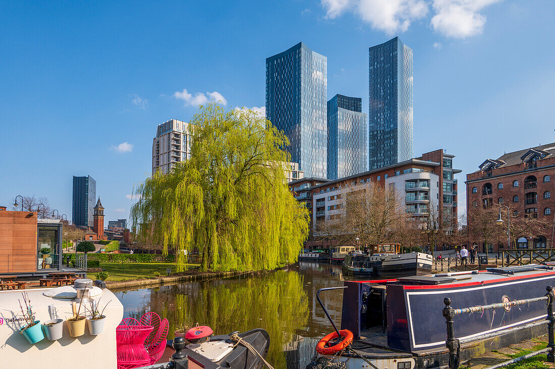 Skyscrapers reflected at Castlefield Basin with canal barges, Manchester, England, United Kingdom, Europe