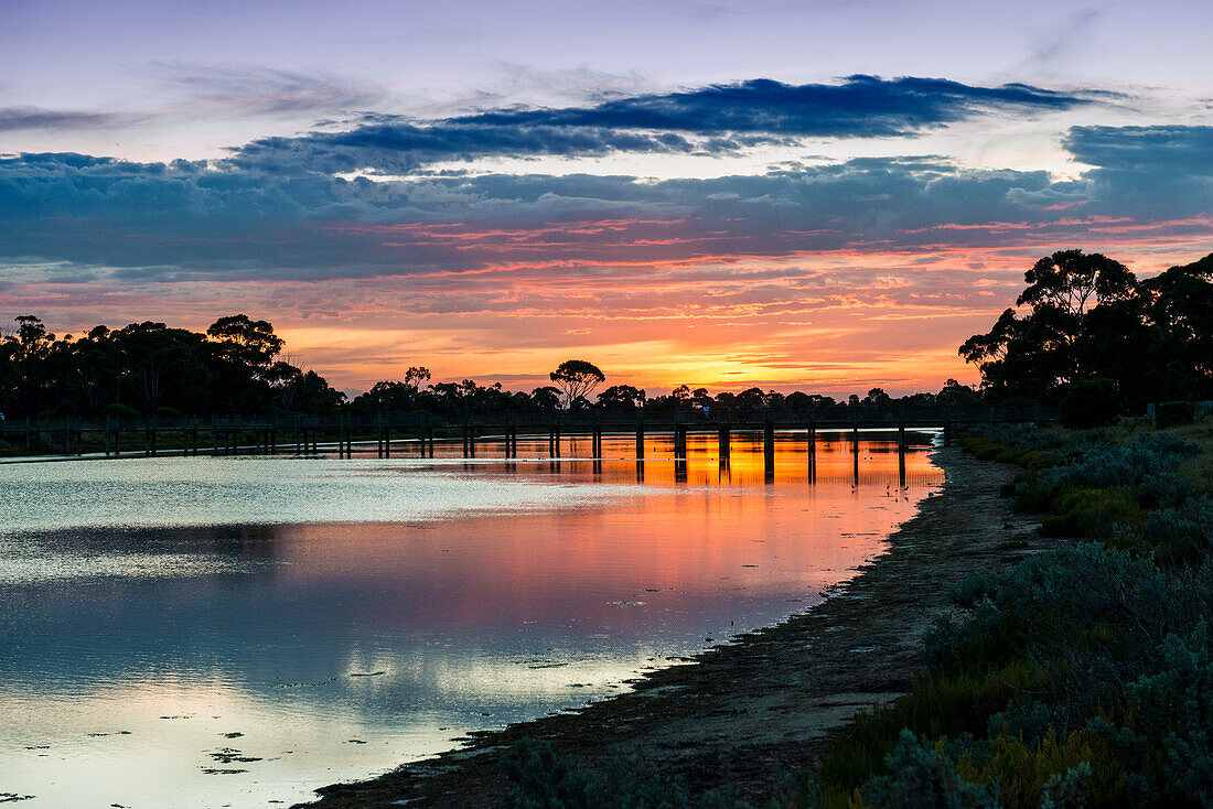 Farben des Sonnenuntergangs über Laverton Creek und Brücke, Altona, Victoria, Australien, Pazifik