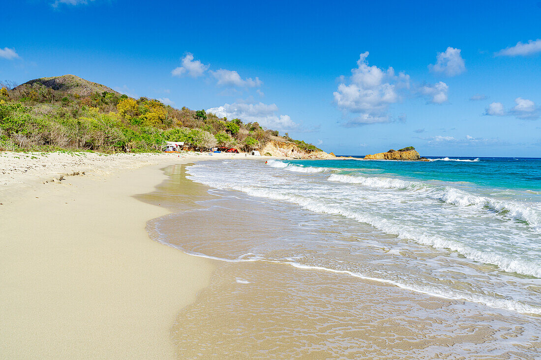 Waves of blue Caribbean Sea crashing on the idyllic tropical Rendezvous Beach, Antigua, Leeward Islands, West Indies, Caribbean, Central America