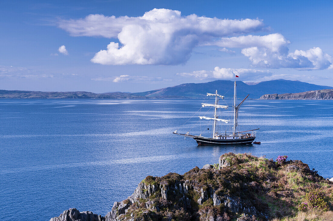 A tall ship moored just north of Mallaig and distant Isle of Skye, Highlands, Scotland, United Kingdom, Europe
