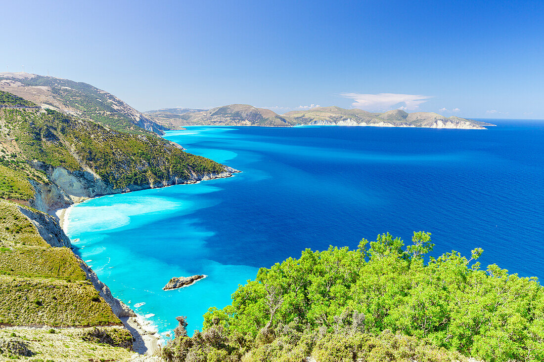 Lush plants on coastline above the turquoise lagoon surrounding Myrtos beach, Kefalonia, Ionian Islands, Greek Islands, Greece, Europe