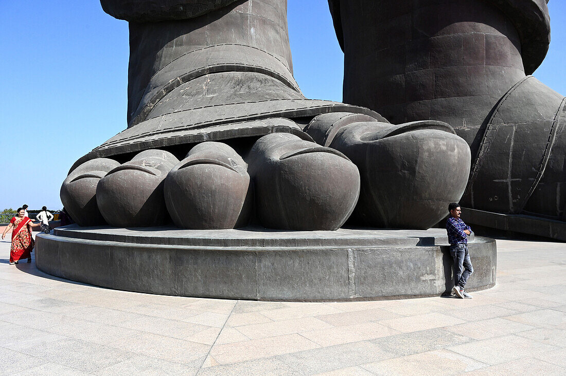 Visitors walking round a foot of The Statue of Unity, the world's tallest statue at 182m of Vallabhbhai Patel, Kevadia, Gujarat, India, Asia