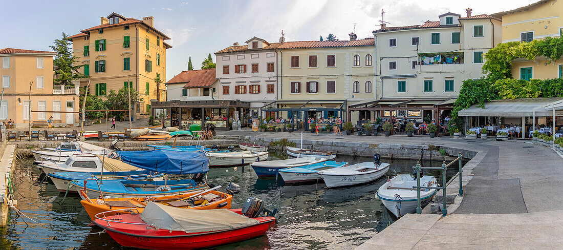 View of boats in the marina and harbourside restaurants during golden hour in Volosko, Opatija, Kvarner Bay, Croatia, Europe