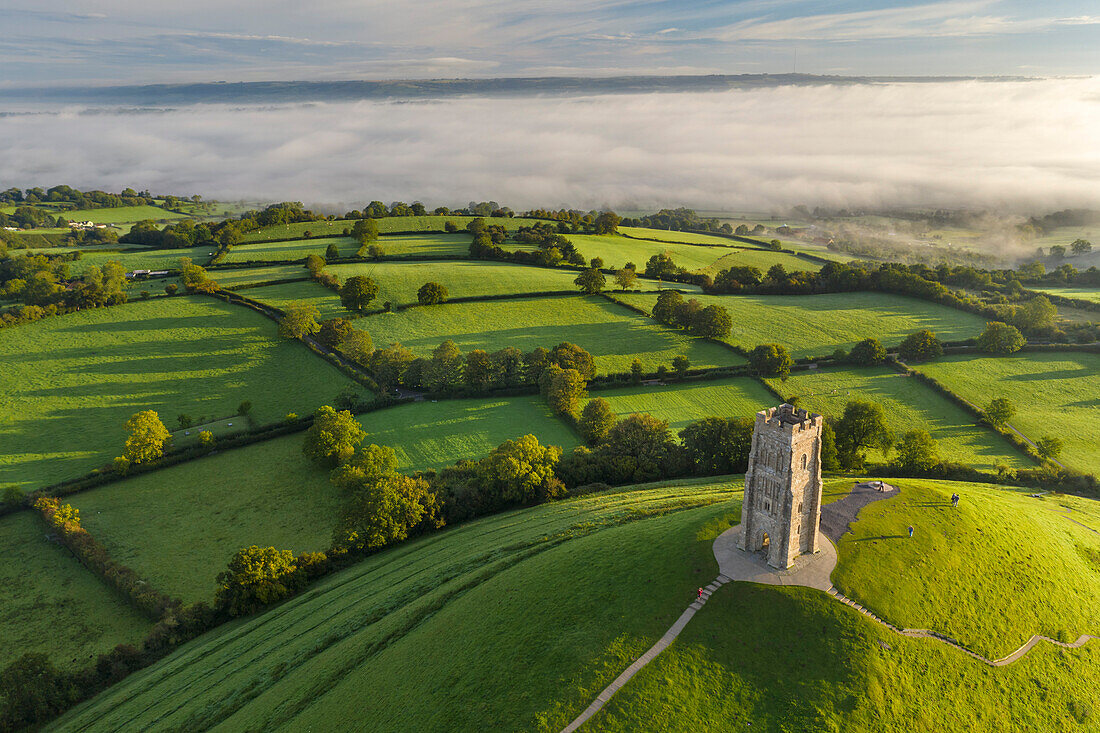 Early morning mists at St. Michael's Tower on Glastonbury Tor in Somerset, England, United Kingdom, Europe