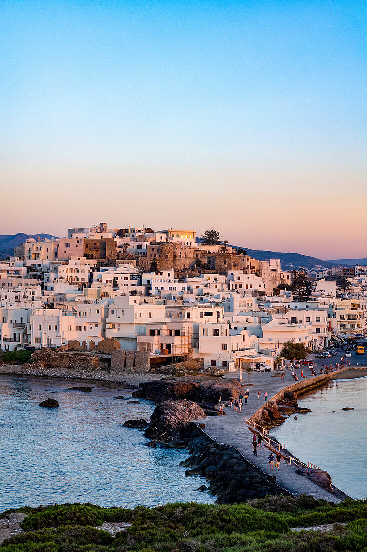 Dusk over Naxos town and causeway to The Porta Gateway, part of the unfinished Temple of Apollo, Naxos, the Cyclades, Aegean Sea, Greek Islands, Greece, Europe