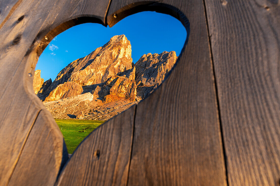 View of the Sass de Putia through a heart shaped hole at dusk, Passo delle Erbe, Dolomites, South Tyrol, Italy, Europe