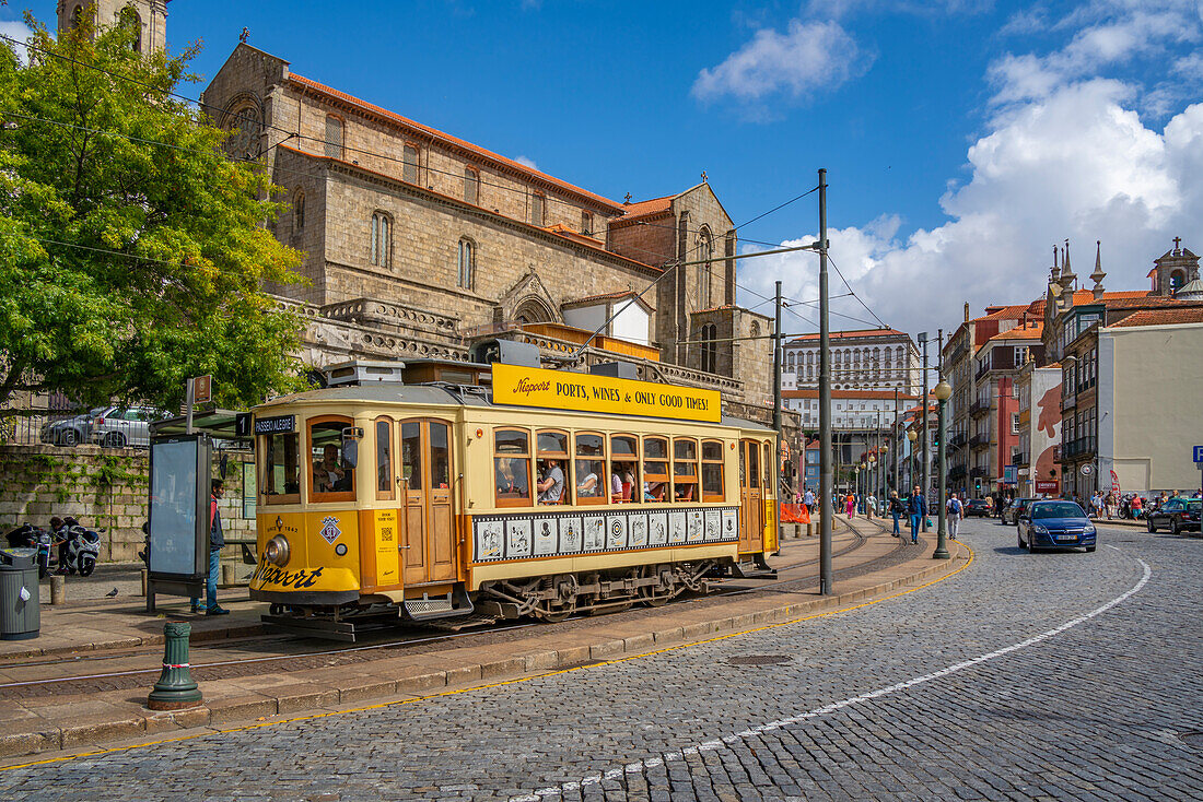 View of city tram with Paco Episcopal do Porto and Ribeira district in background, Porto, Norte, Portugal, Europe