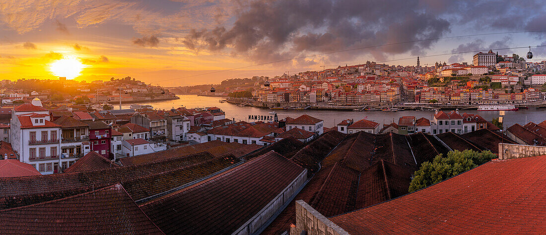 Blick auf den Sonnenuntergang über Terracota-Dächern und dem Fluss Douro in der Altstadt von Porto, Porto, Norte, Portugal, Europa