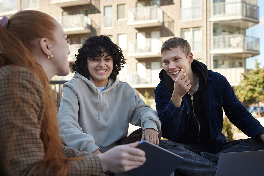 Friends sitting outside together