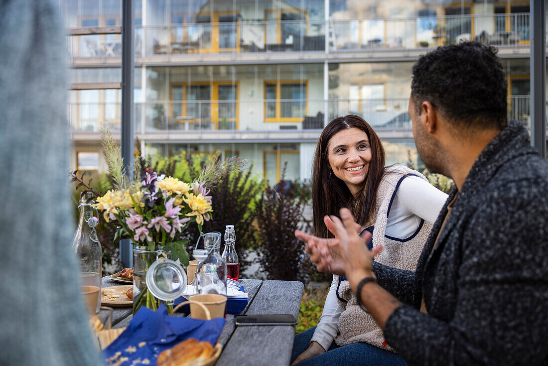 Neighbors having outdoor meal in courtyard