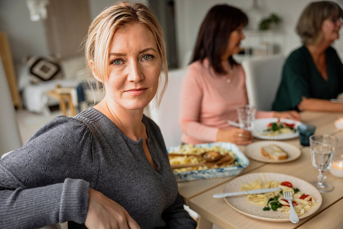 Portrait of woman having dinner with family