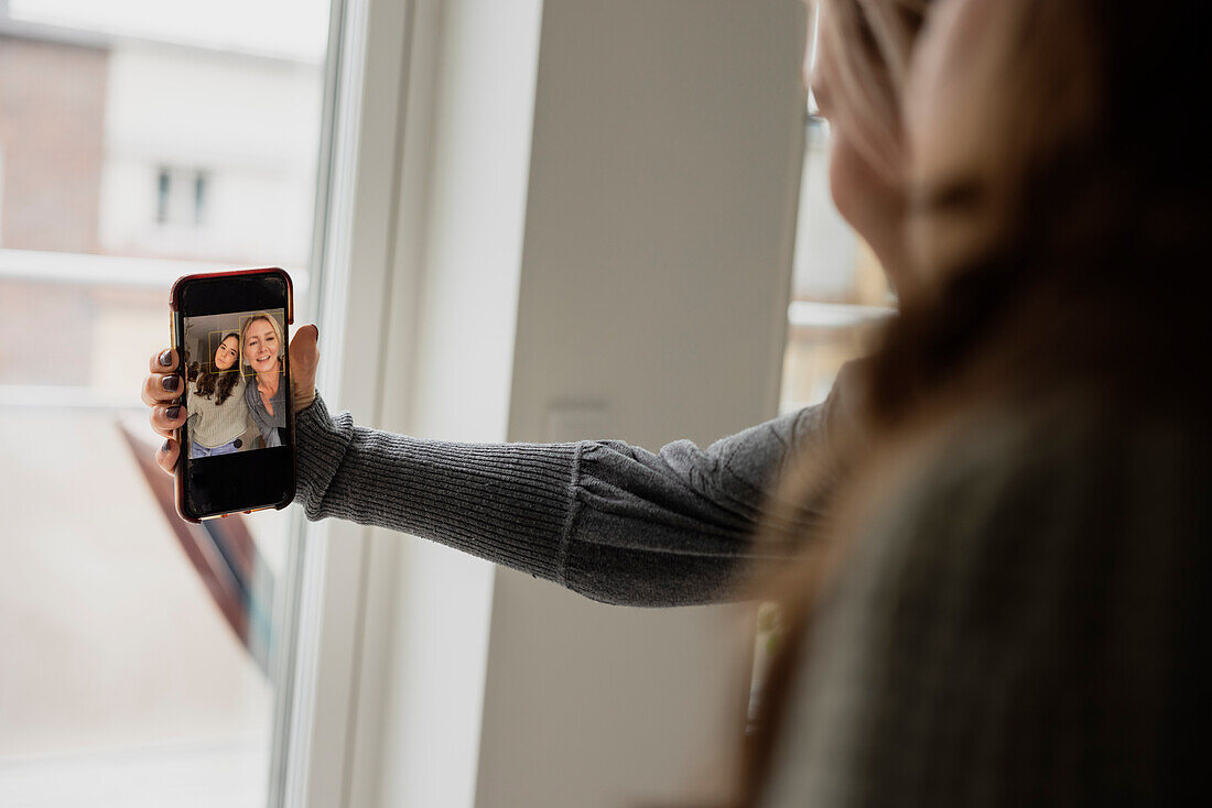 Mother and daughter taking selfie