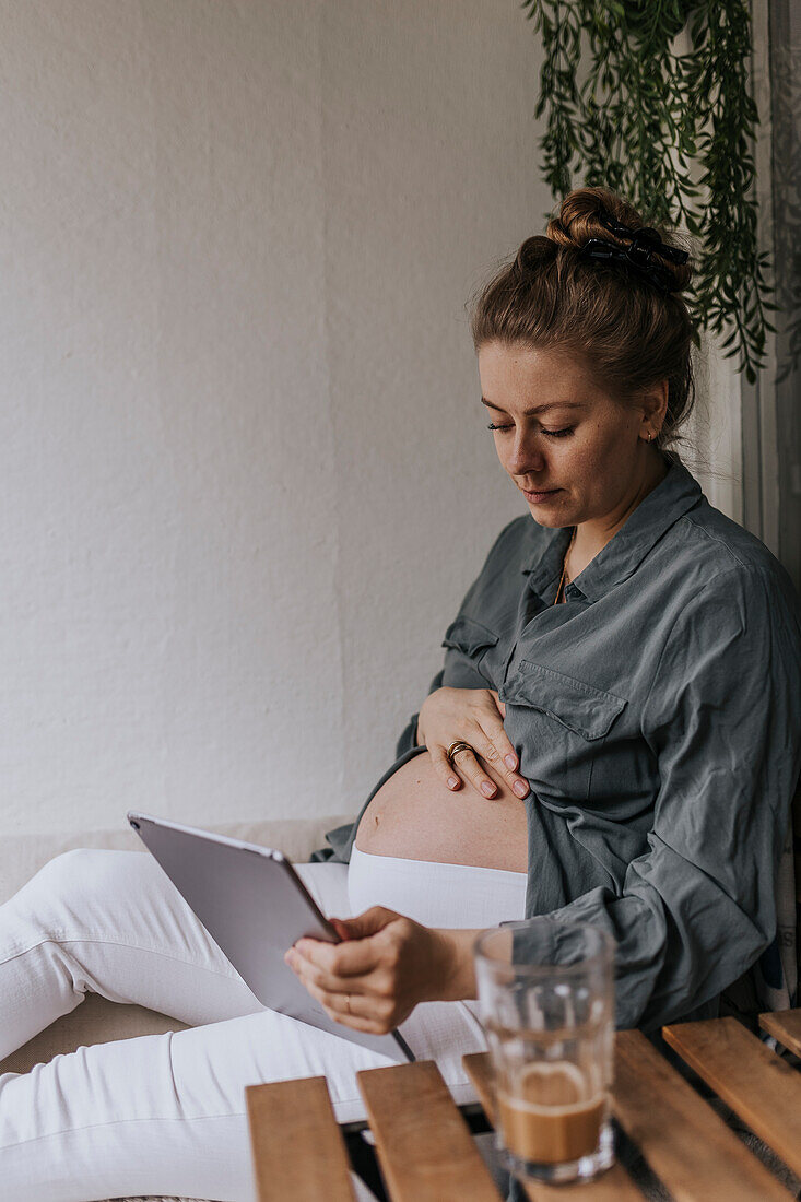 Pregnant woman using digital tablet