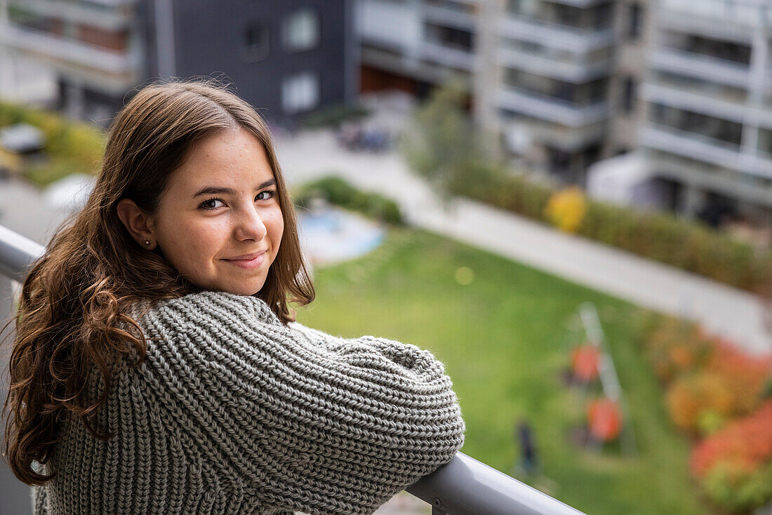Portrait of teenage girl on balcony