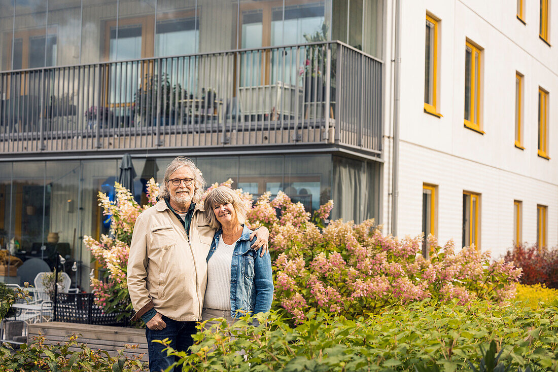 Portrait of smiling senior couple in residential area
