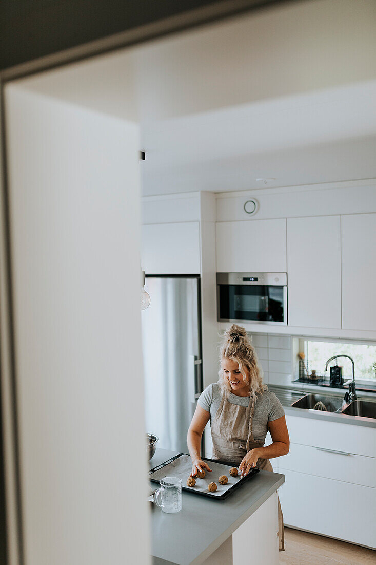 Woman preparing cookies in kitchen