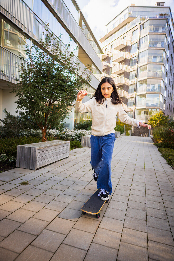 Girl skateboarding in residential area